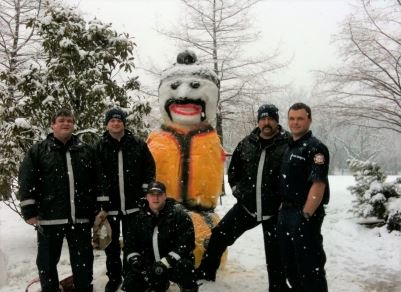 Firefighters with Large Snowman