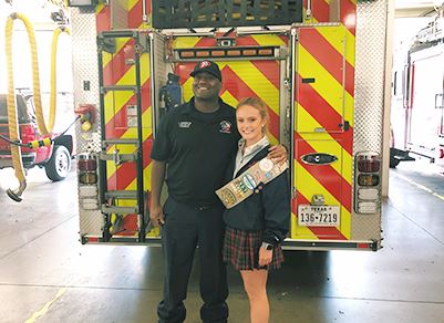 Girl Scout with Member of Fire Department