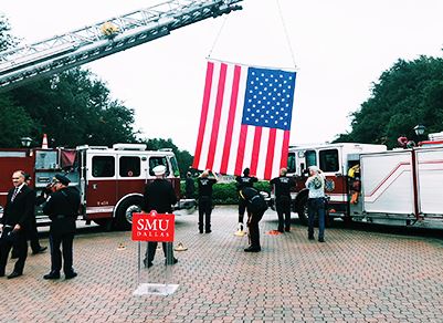 Firefighters Raising Flag Using Fire Truck Ladder