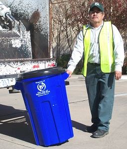 Sanitation Worker Holding Blue Recycling Container